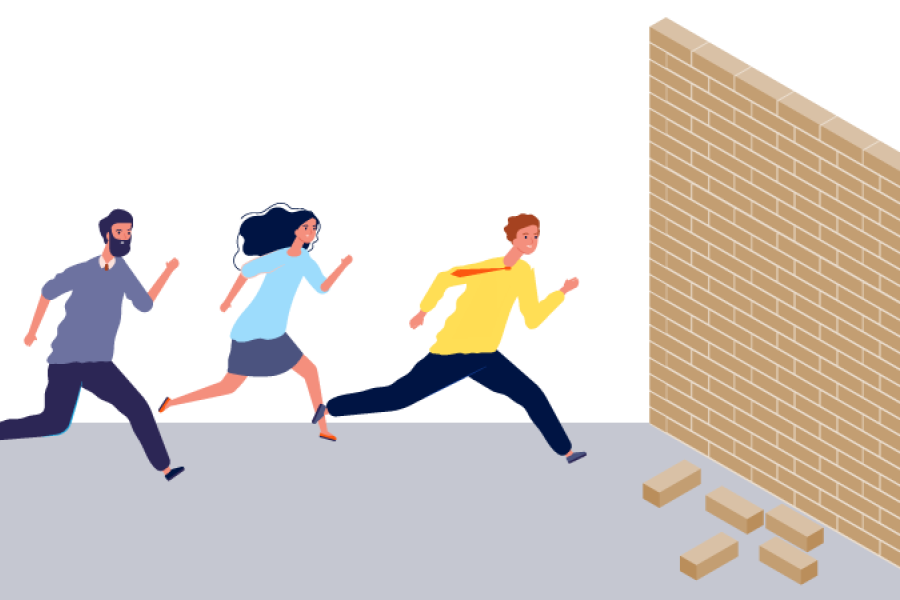 a group of people running towards a brick wall